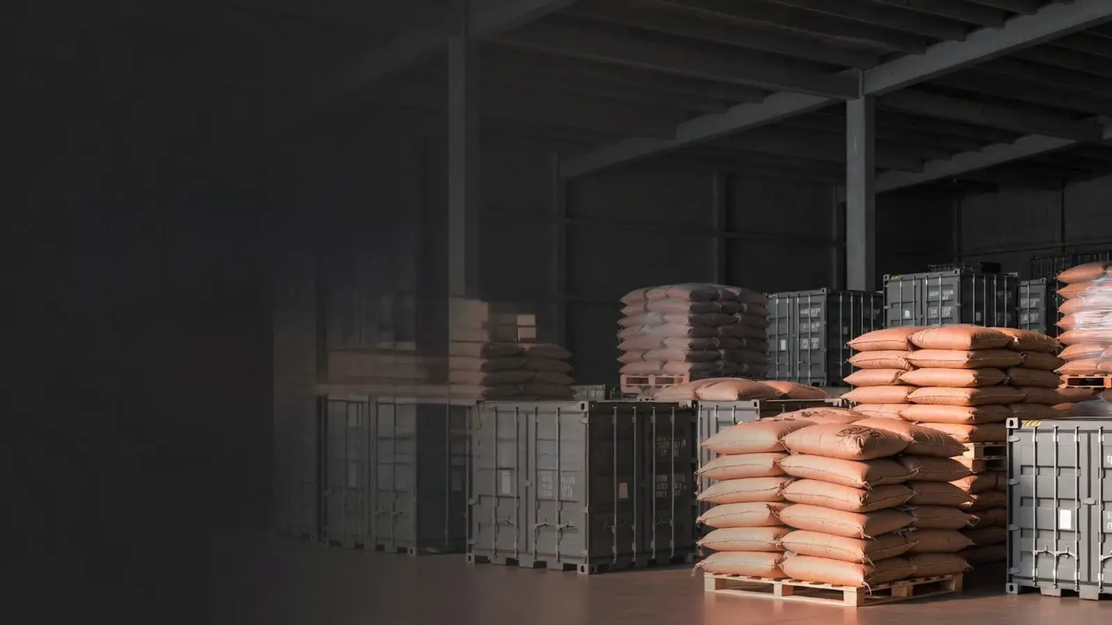 Sacks and packaged goods stacked on pallets in a warehouse